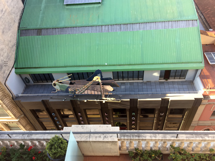 Overhead view of the giant grasshopper sculpture on top of the Barcelona Surveyors' Association building
