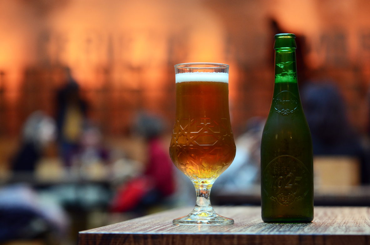 Cervezas Alhambra beer bottle sitting next to served glass on table
