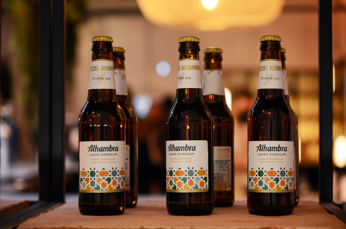 Bottles of Cervezas Alhambra beer sitting in row on shelf