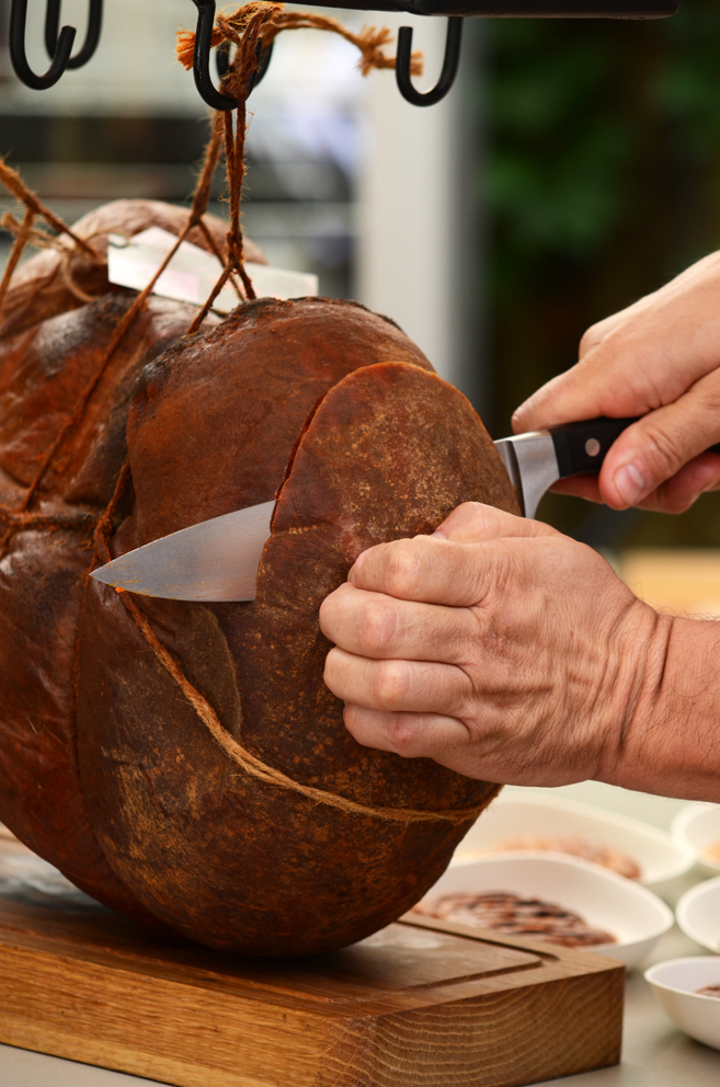 Sobrasada being cut with a butcher's knife